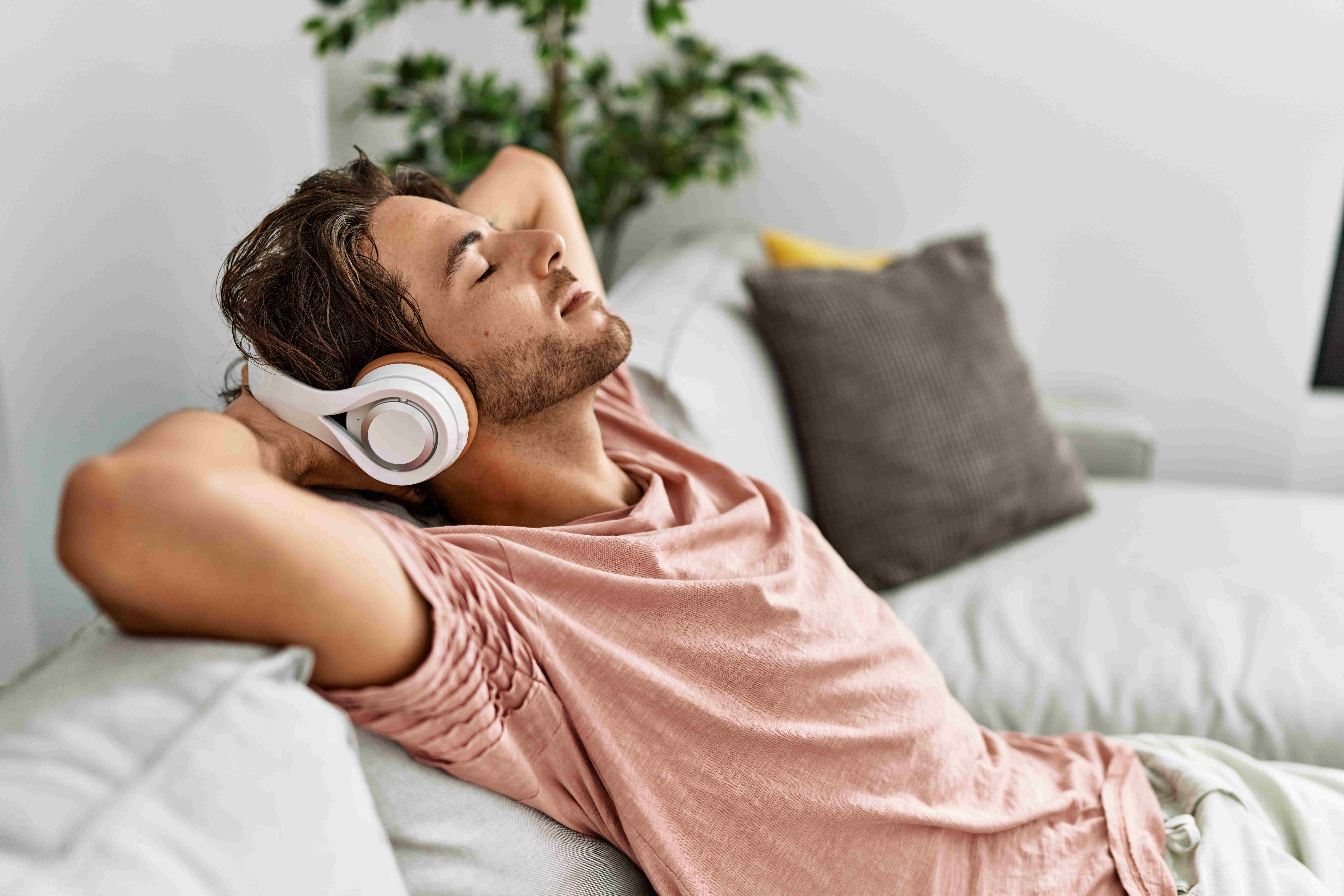 A college graduate is finally able to relax and listen to music on his headphones.