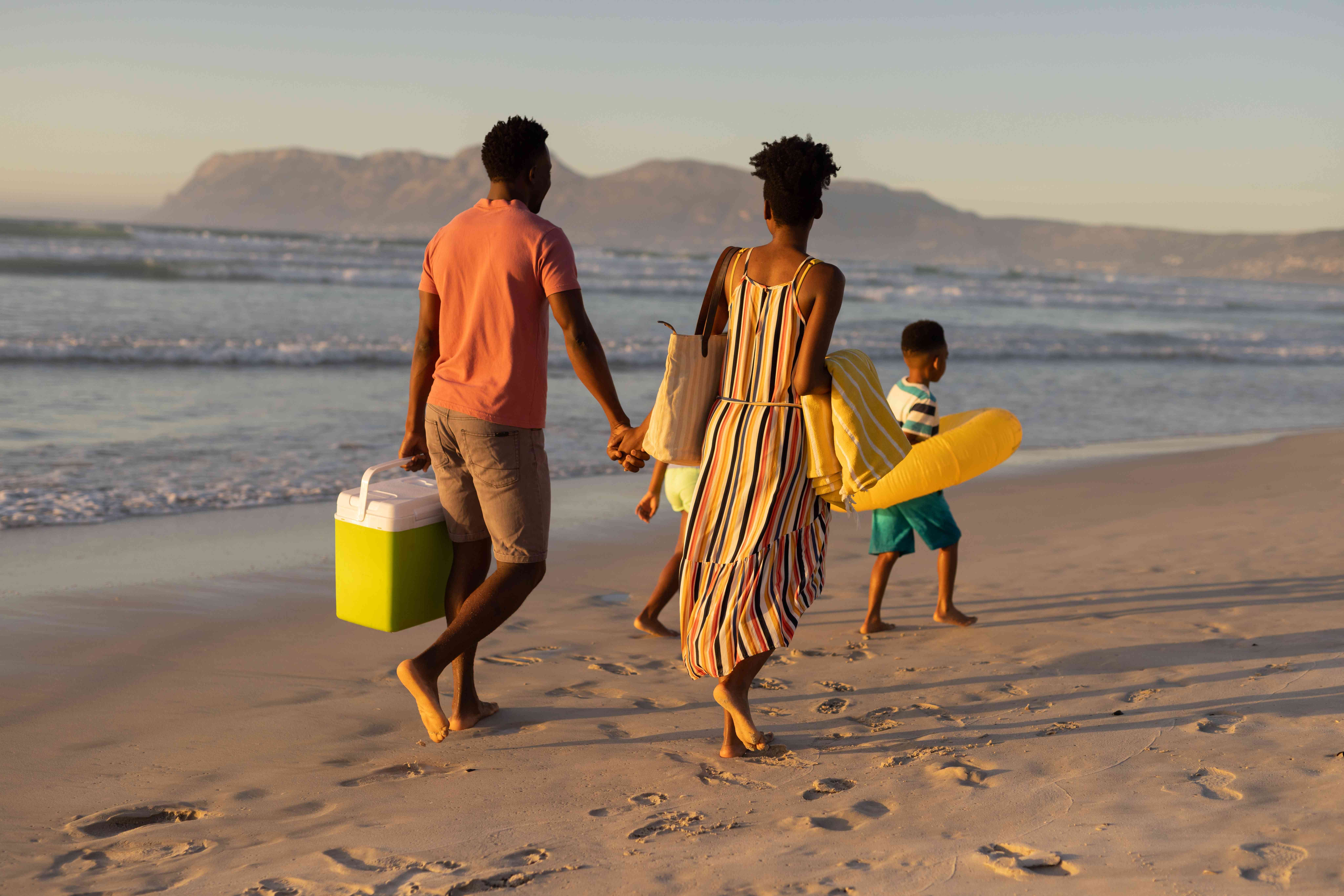 A family takes a beverage cooler on their last-minute trip to the beach.