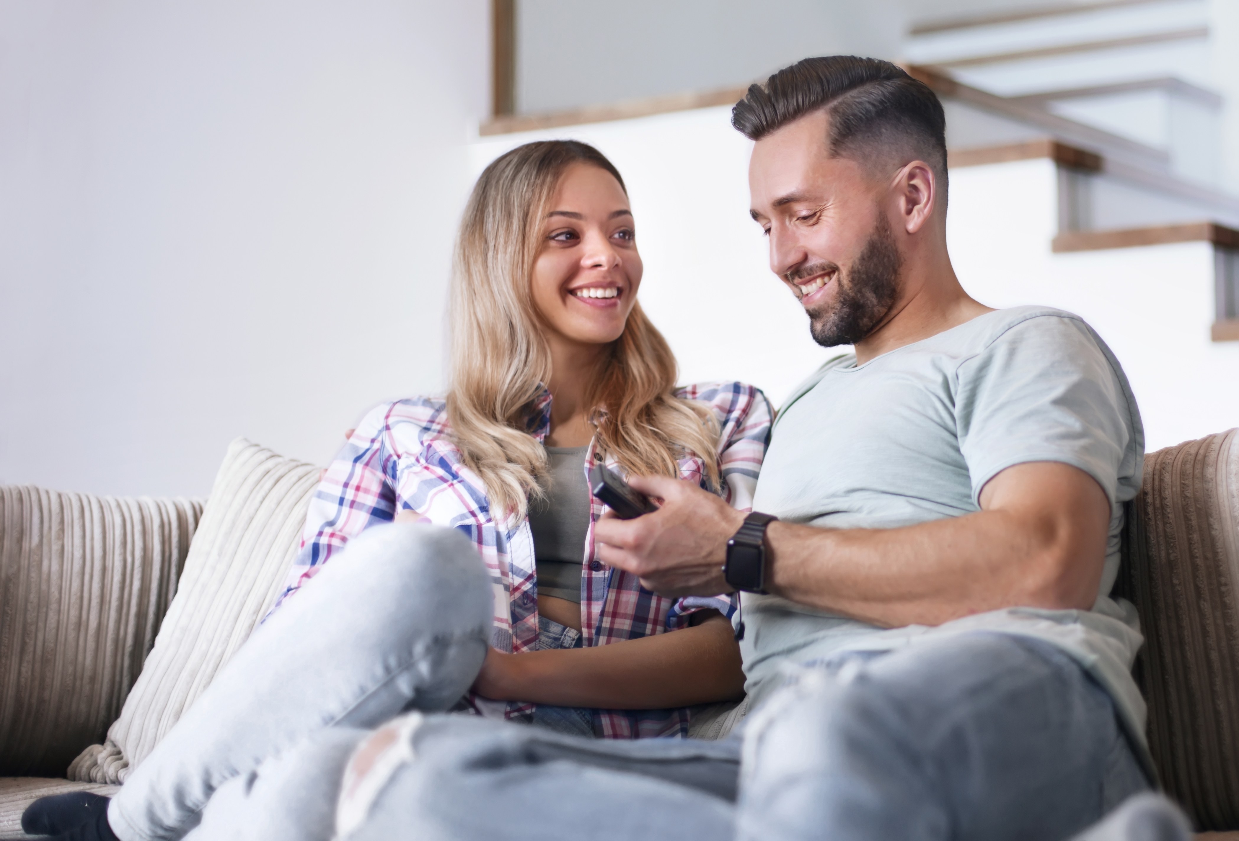 A young dad watches TV using the streaming device he got for Father’s Day.