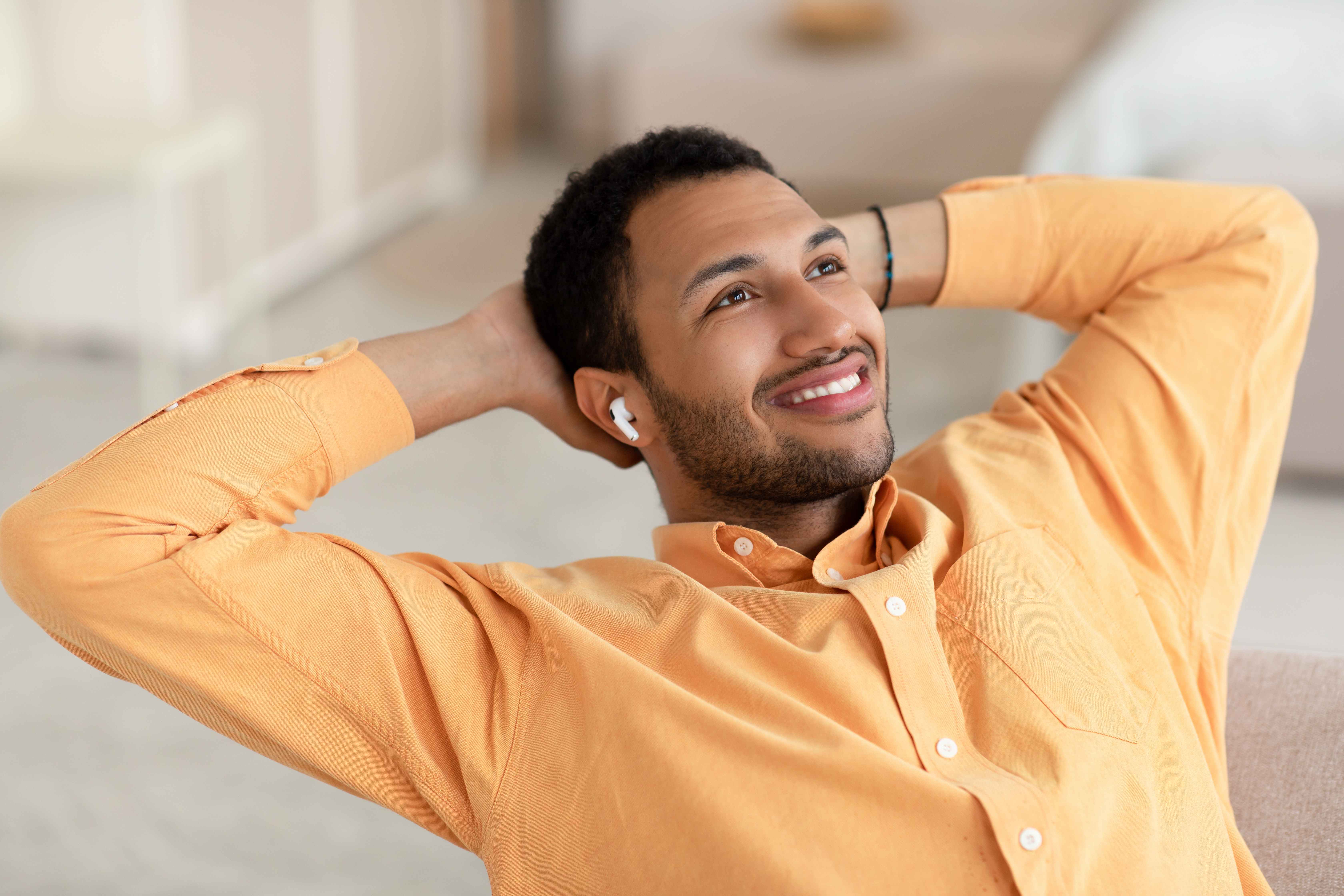 A relaxed dad listens to music on the earbuds he received as a Father’s Day gift.