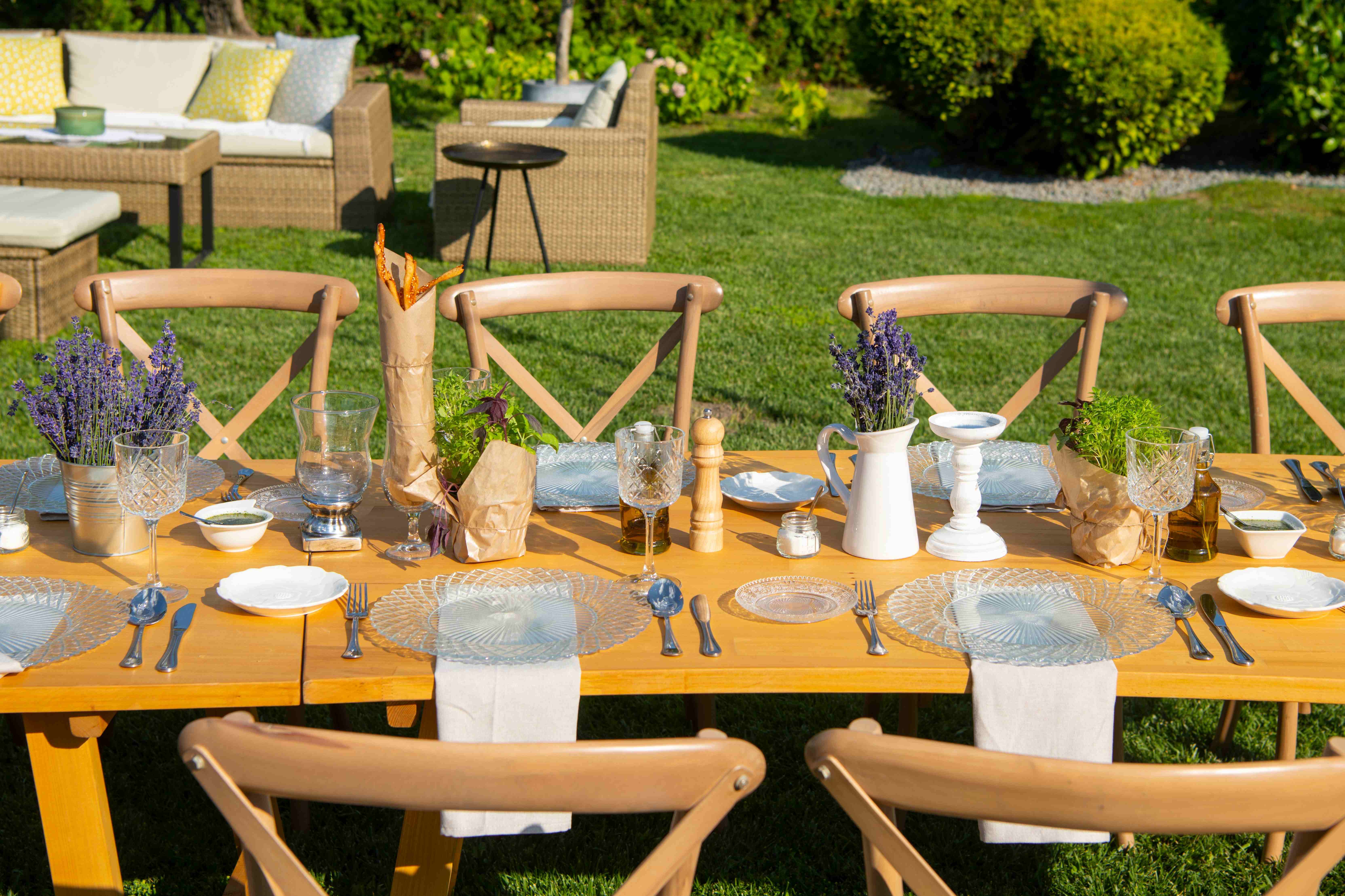A table setting with outdoor-friendly dishes for a summer barbecue-themed baby shower