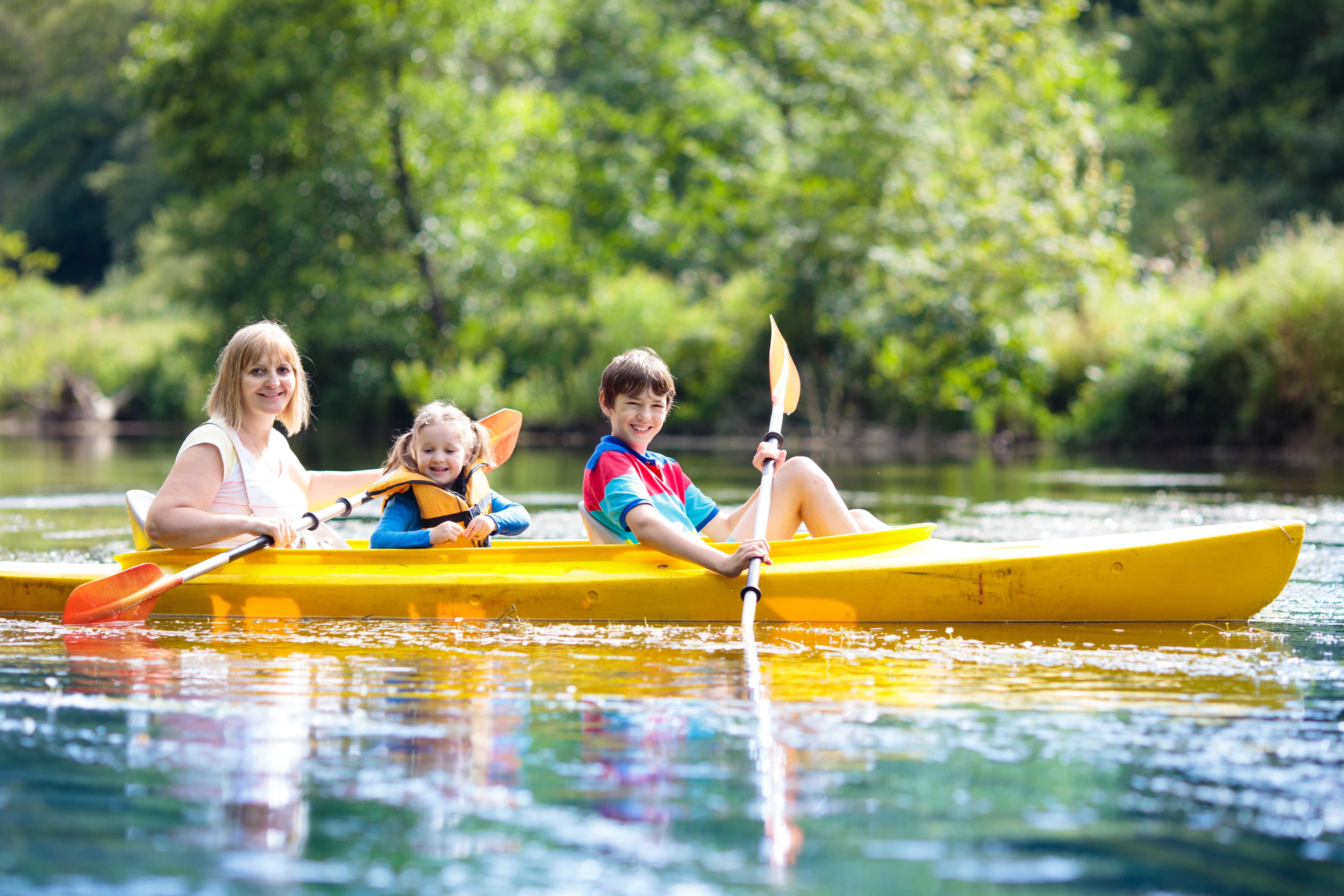 A mother and her kids enjoy summer fun on a family boat ride