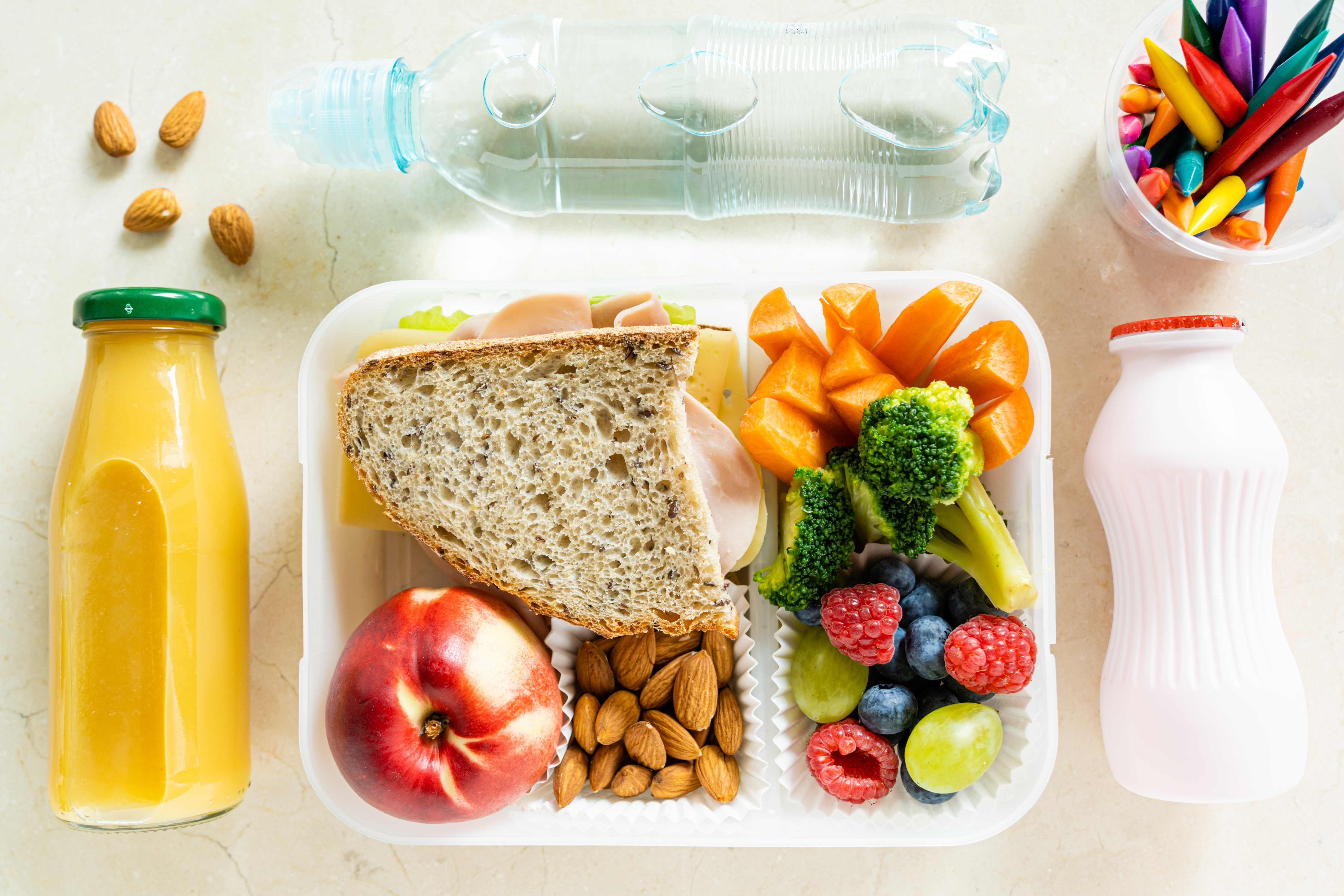 An organized lunch box filled with healthy food for a child to bring to school