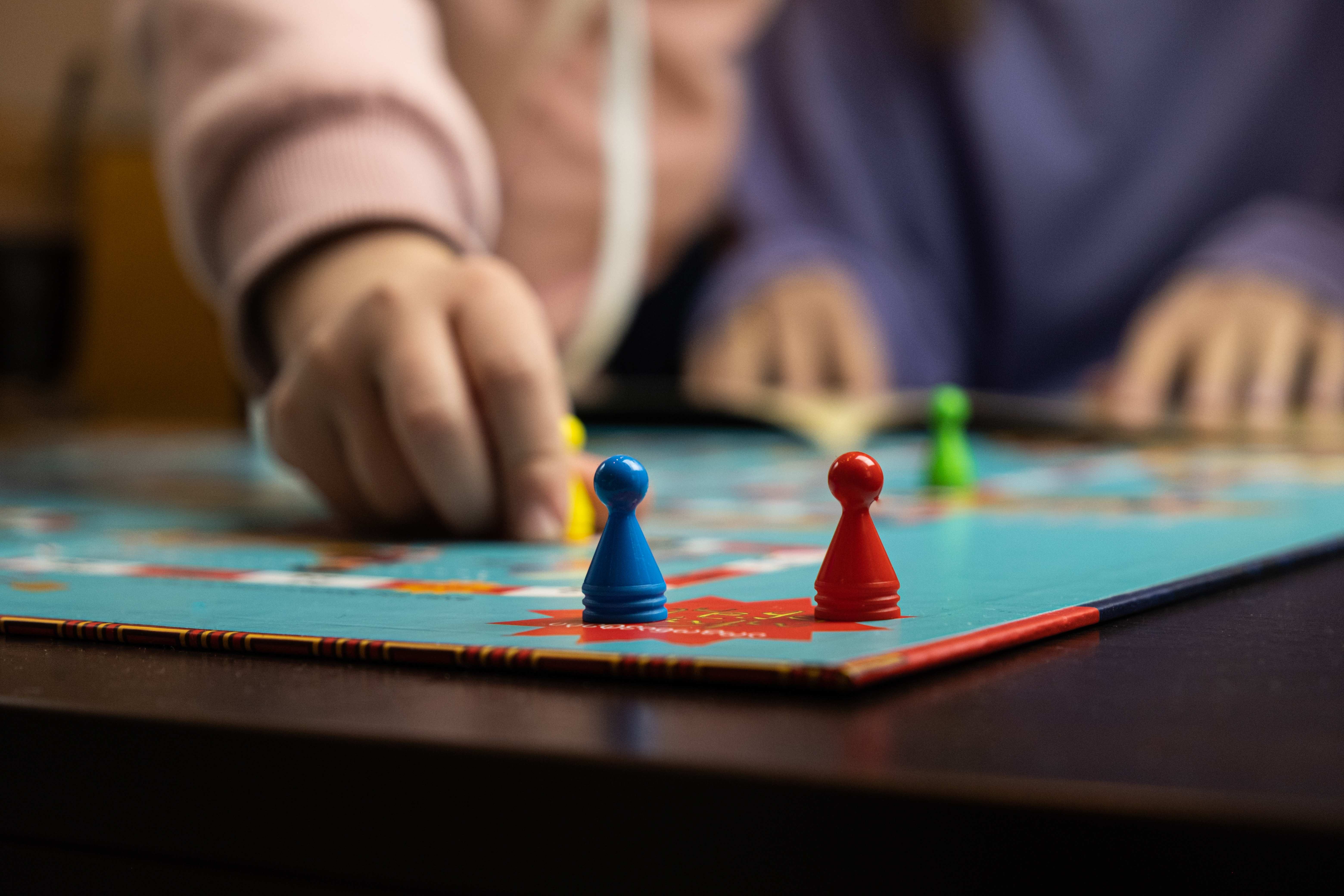 A family plays a board game together after the Thanksgiving meal.
