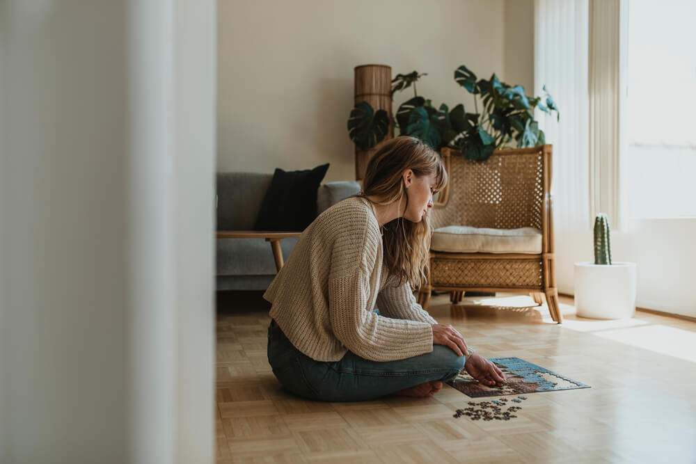 A woman assembles the personalized puzzle she received as a gift from her fiancé.