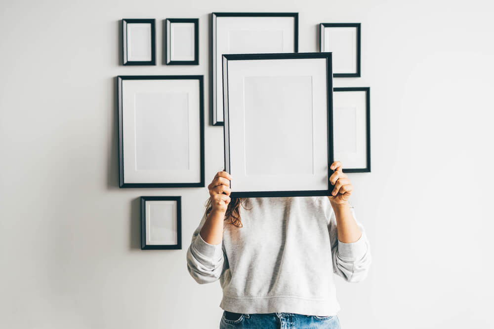 A woman is ready to frame her favorite proposal and engagement photos.