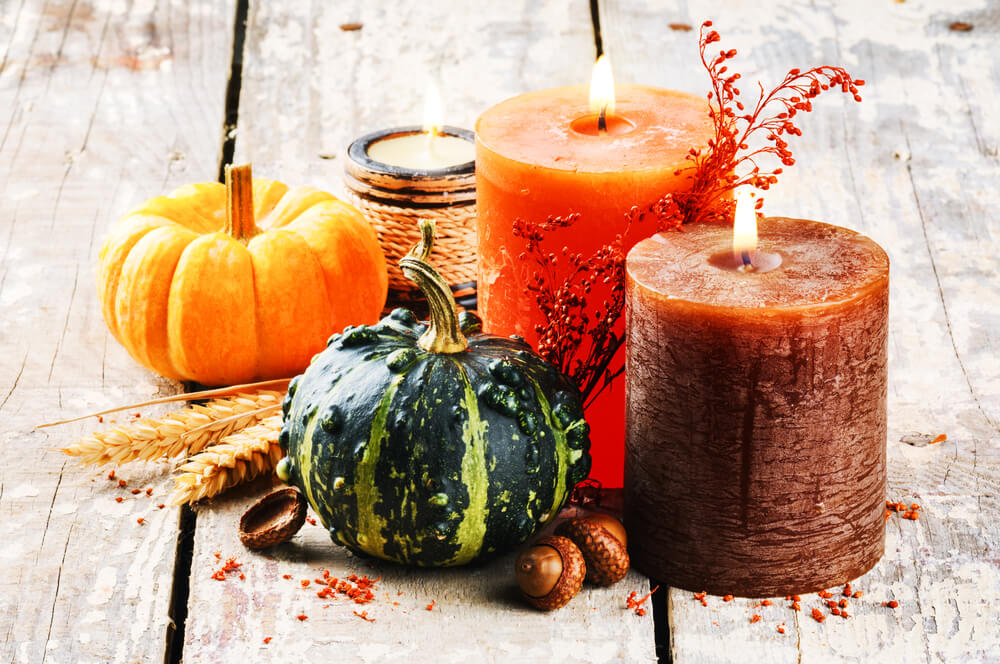 A collection of cozy scented candles that are perfect for autumn.