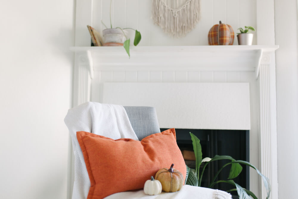 A cozy living room decorated for fall with seasonal home items.