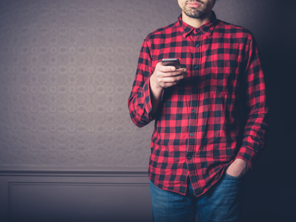 A man wears a cozy flannel shirt that he received as a gift.
