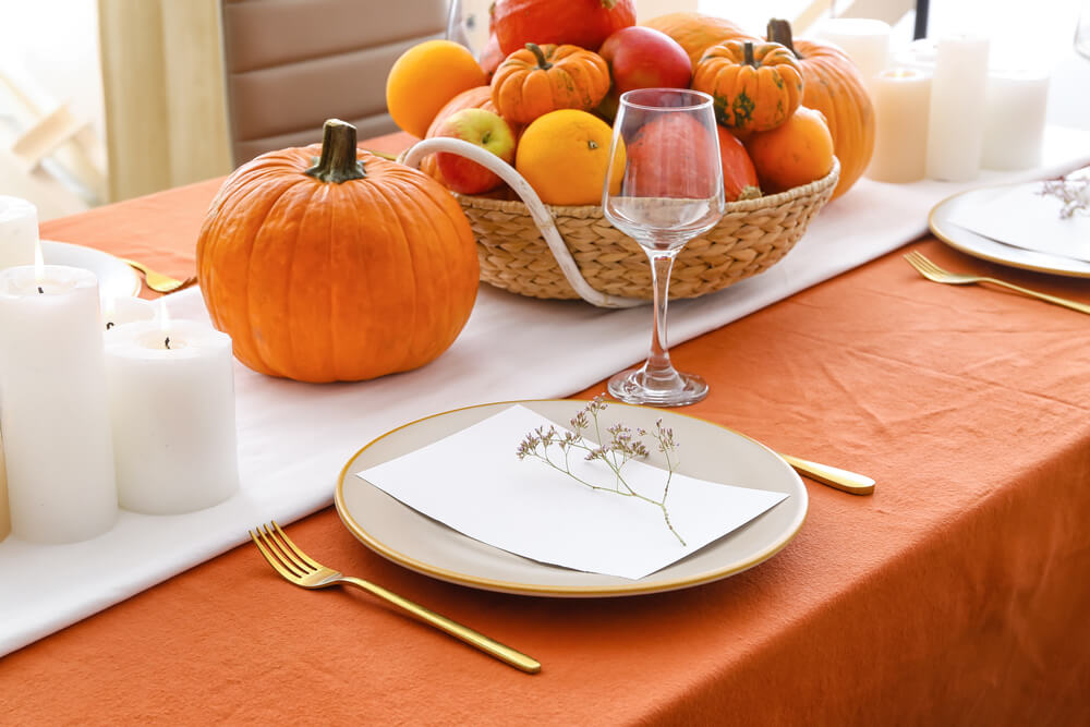 A beautiful table set for autumn with seasonal centerpieces.