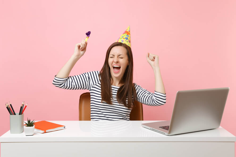 A hardworking Virgo woman celebrates her birthday at her desk.