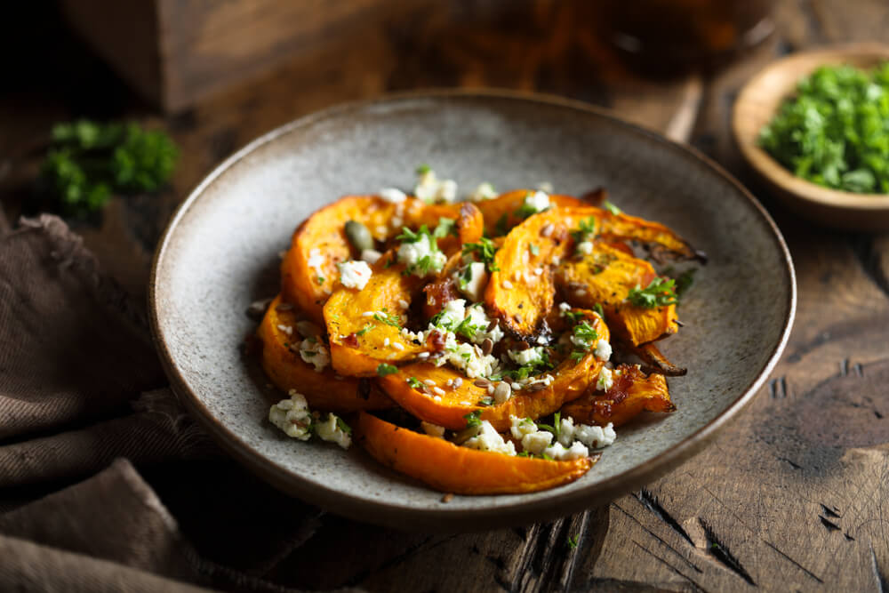 The table is set for a family dinner featuring delicious fall vegetables.