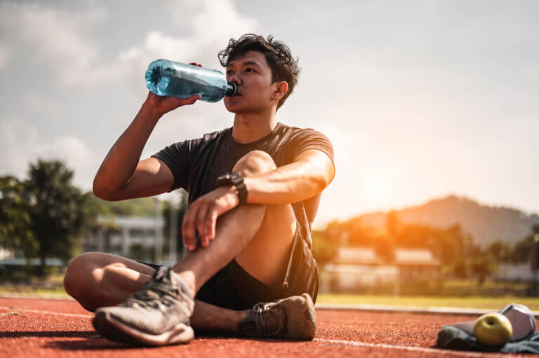 A healthy young man takes advantage of summer weather and exercises outdoors.