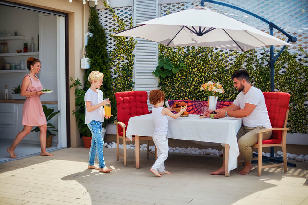 A family enjoys one last meal together on the patio outdoors before summer ends.