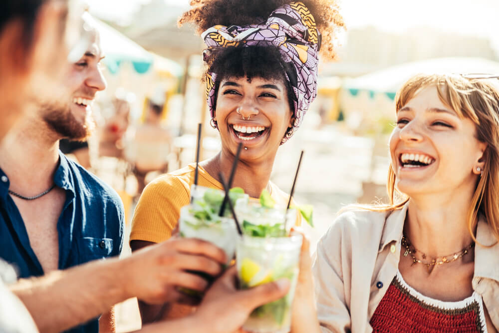 A group of friends gets together outdoors for cocktails before summer ends.