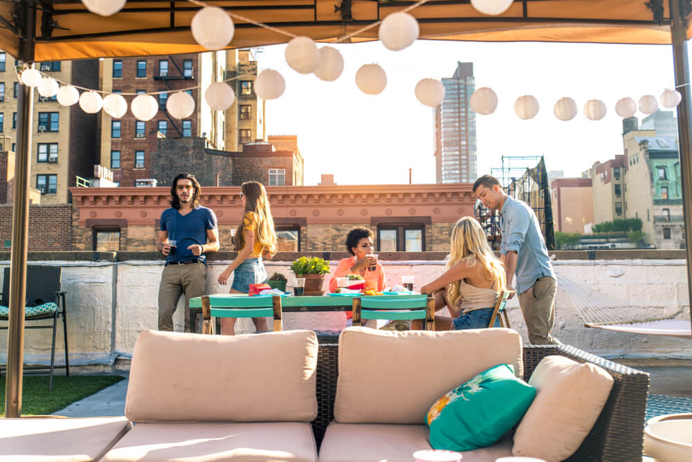 Young twenty-somethings visit a rooftop bar to check it off their summer bucket list.