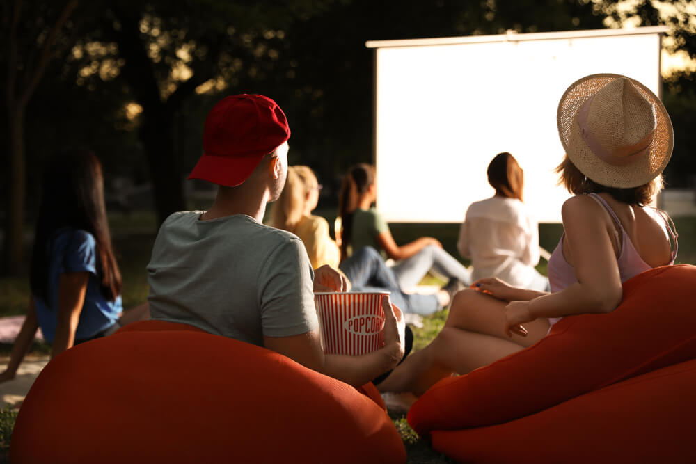 A summer movie night is one of the best outdoor activities to host in your backyard.