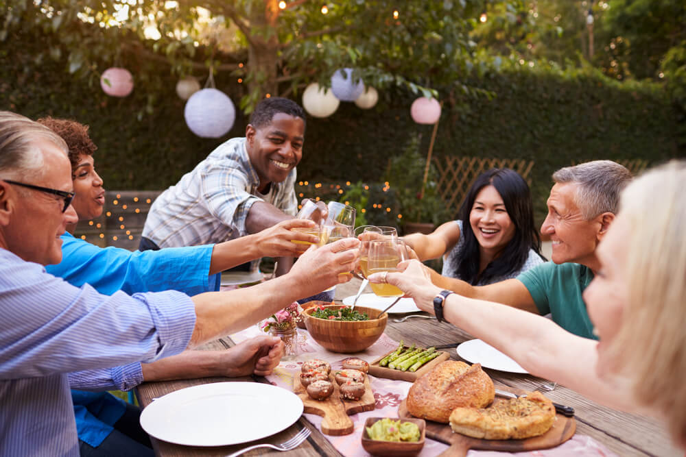 Friends and family members have fun at an end of summer party outdoors.