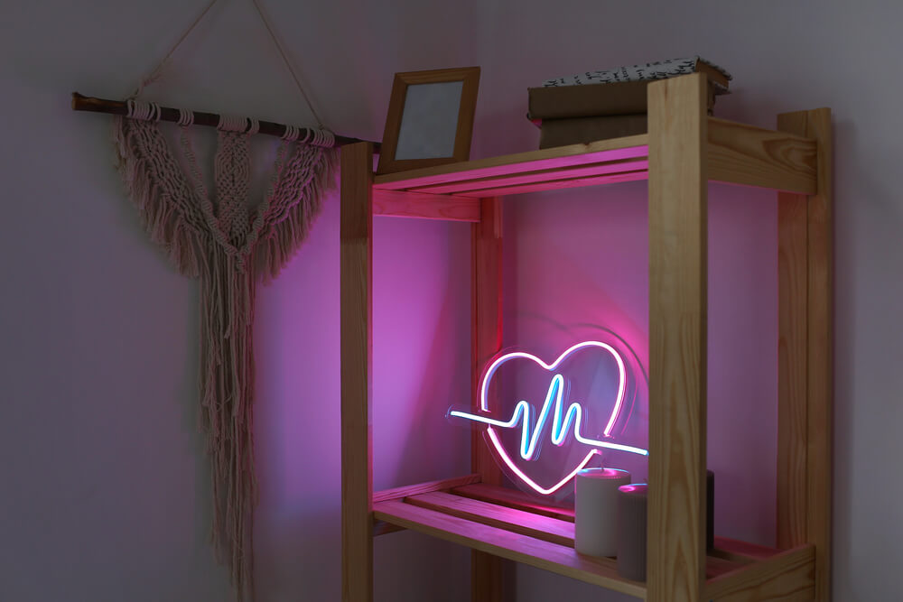 A decorative neon sign to brighten up a bold Leo woman’s bedroom.