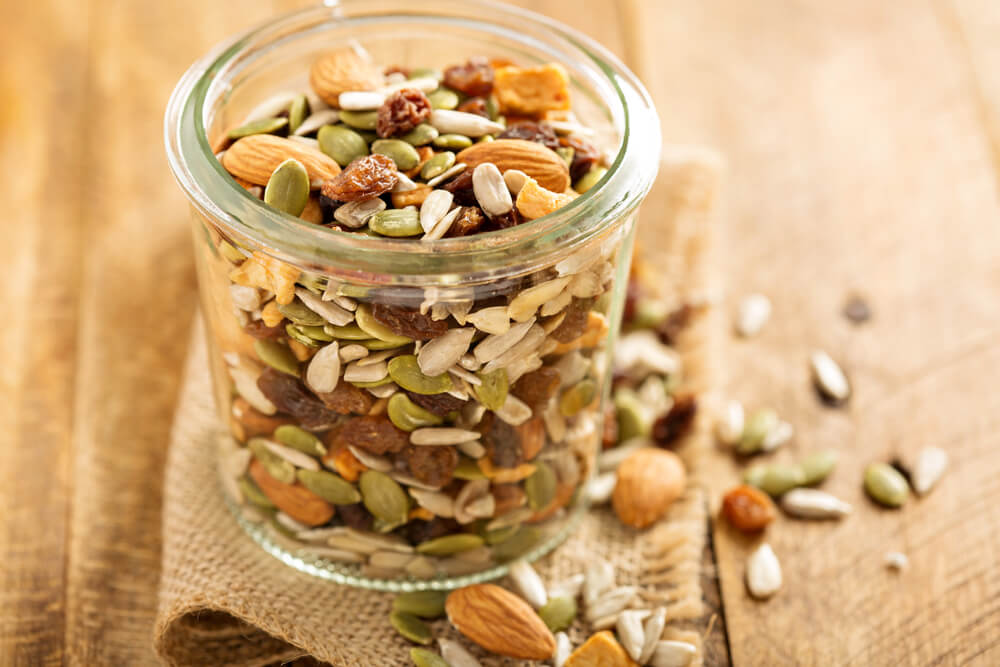 A jar of trail mix perfect for a long hike or a family road trip.