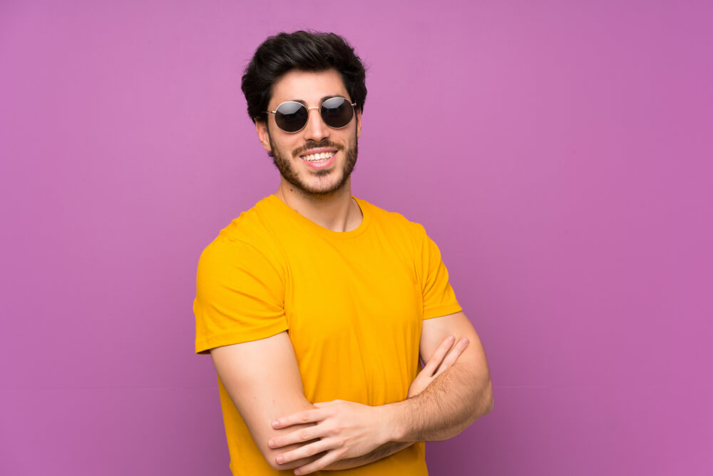 A man whose zodiac sign is Cancer wears a pair of cool sunglasses.