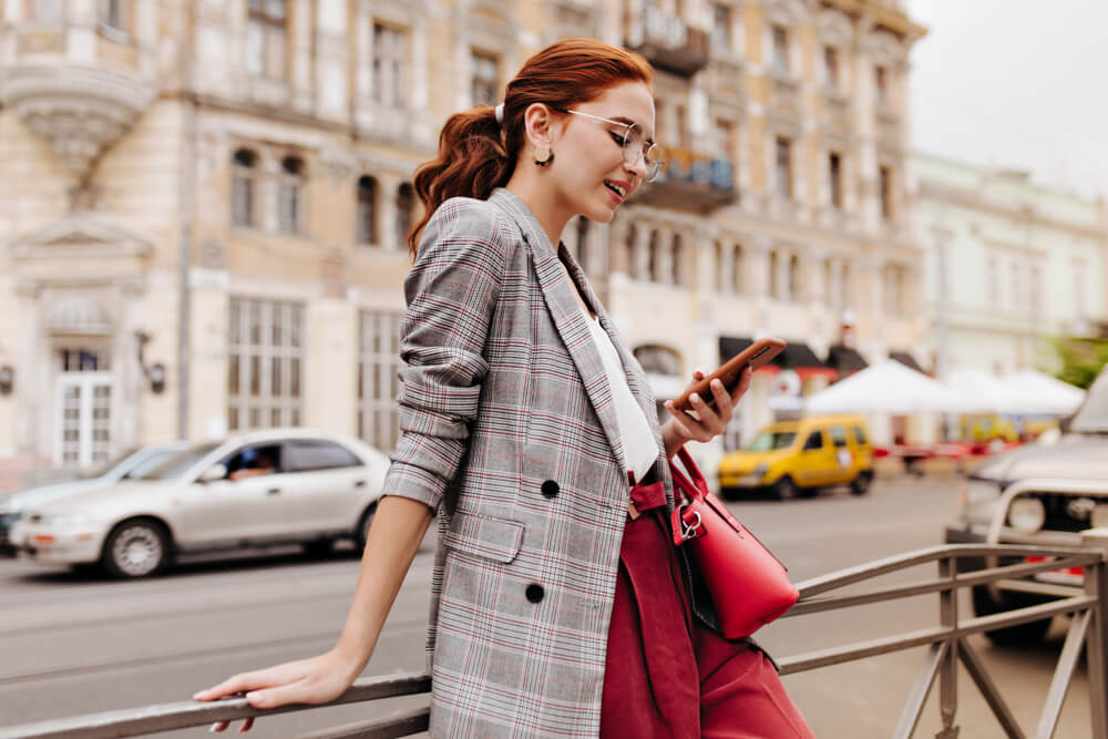 A stylish business woman wears a plaid blazer.