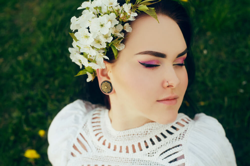 A woman with a unique sense of style wears winged eyeliner.
