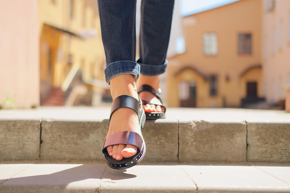 A cool alternative woman wears a unique pair of sandals.