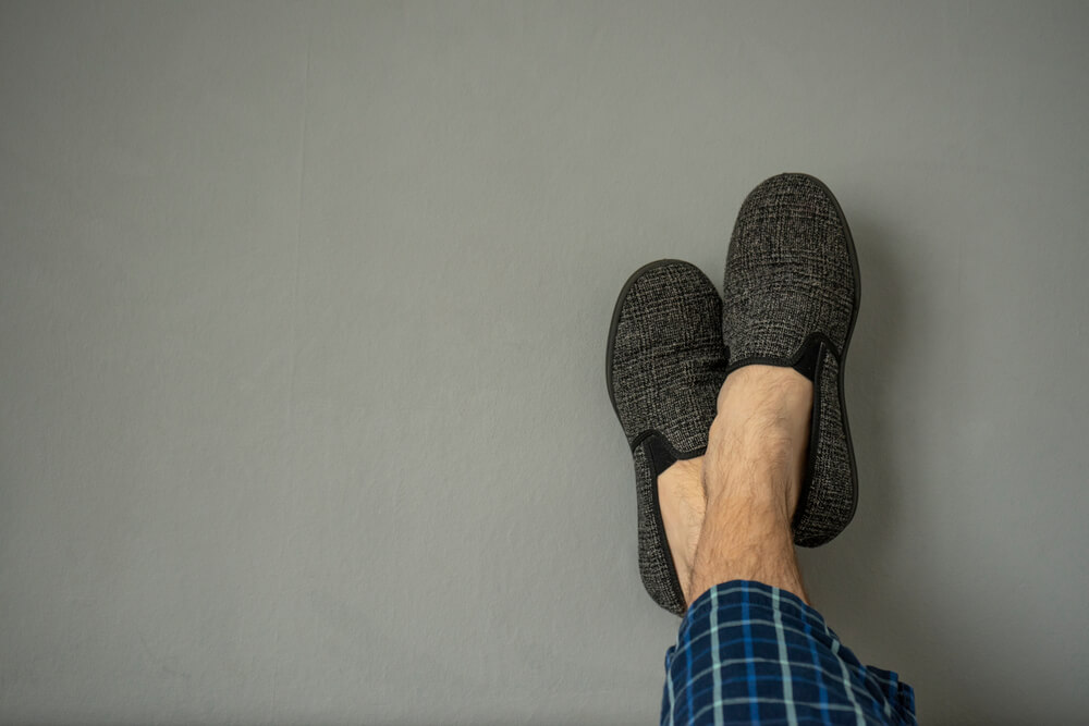 A Taurus dad gets comfy in the new slippers he received for Father’s Day.