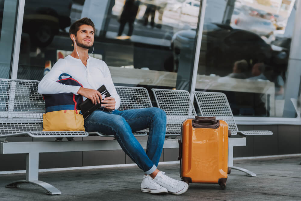 A well-traveled Sagittarius man waits to board his next flight.