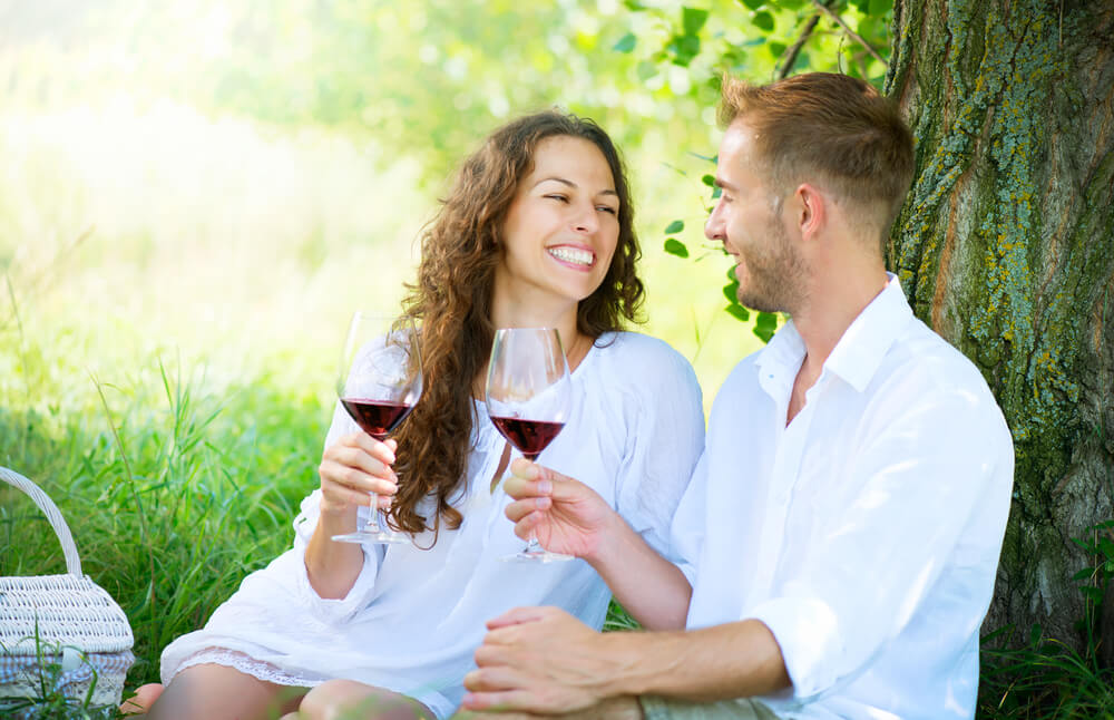 A couple in love celebrates their wedding anniversary with a glass of wine.