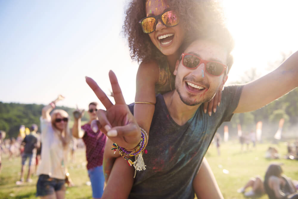A happy couple is excited to be at a music festival for their wedding anniversary.