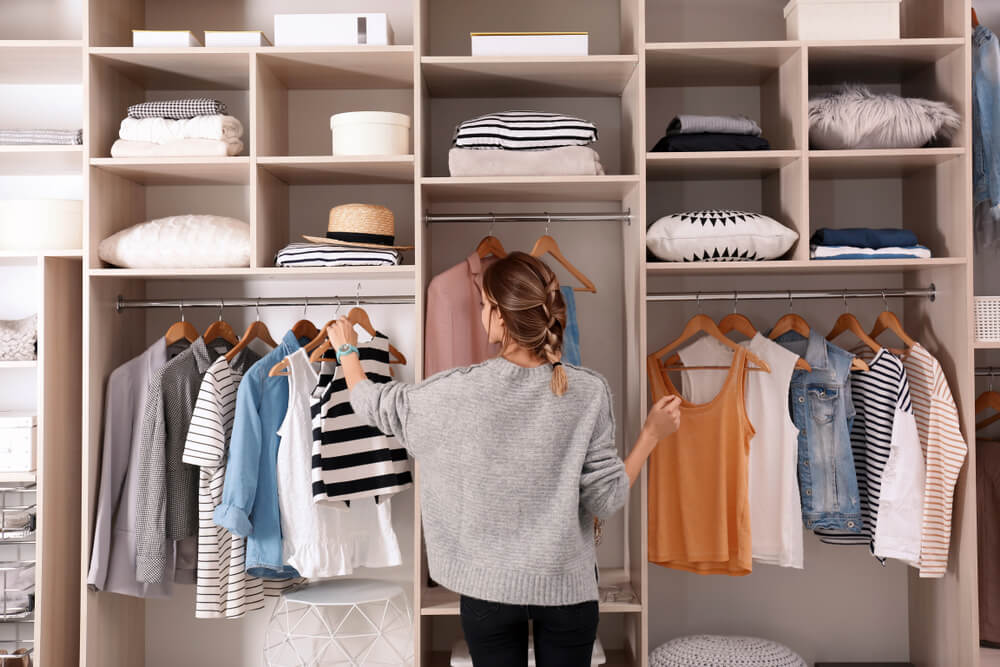 A woman enjoys the closet organizers she received as a thoughtful gift.
