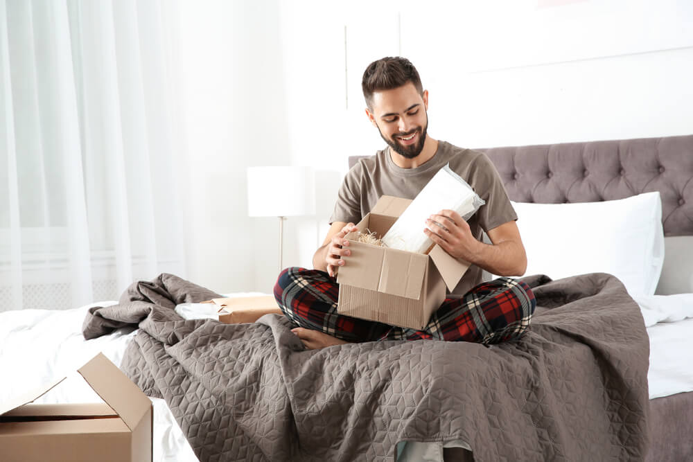 A happy Dad opens a long-distance Father’s Day gift from his kids.