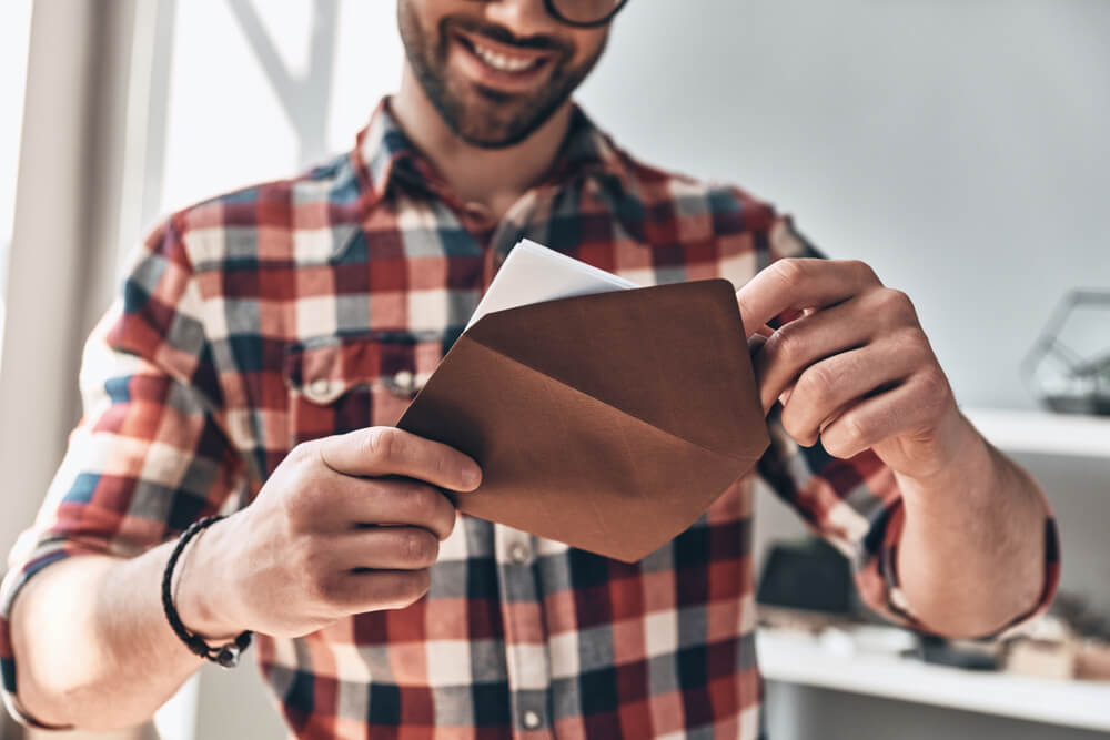 A Dad is excited to open a Father’s Day card from his family.