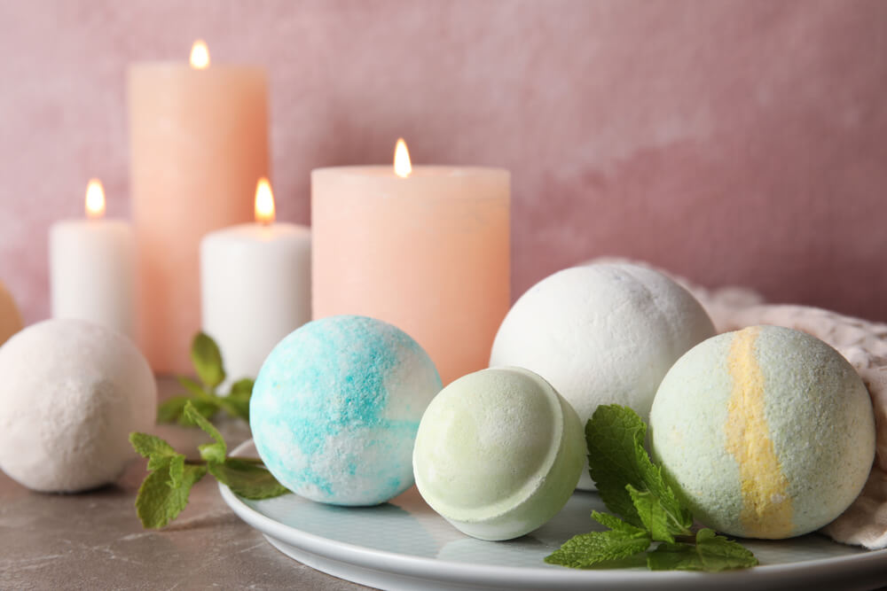 Bath bombs and candles for a relaxing self-care day at home.