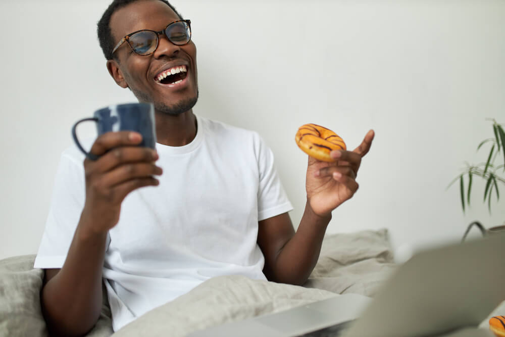 A dad enjoys a long-distance video call from his kids over breakfast.