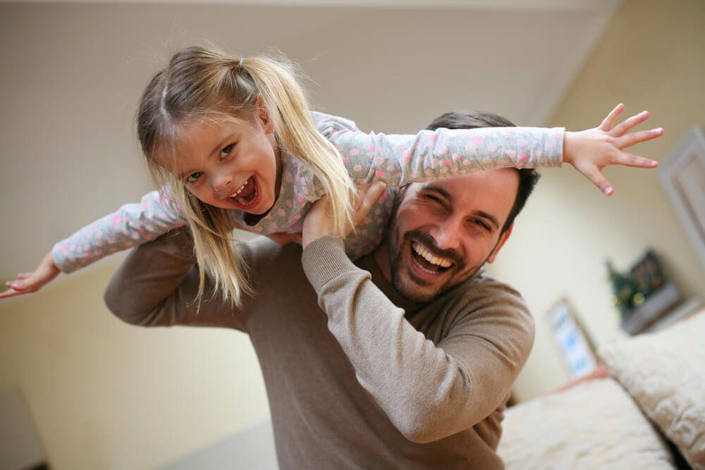 A single dad spends quality time playing with his young daughter.