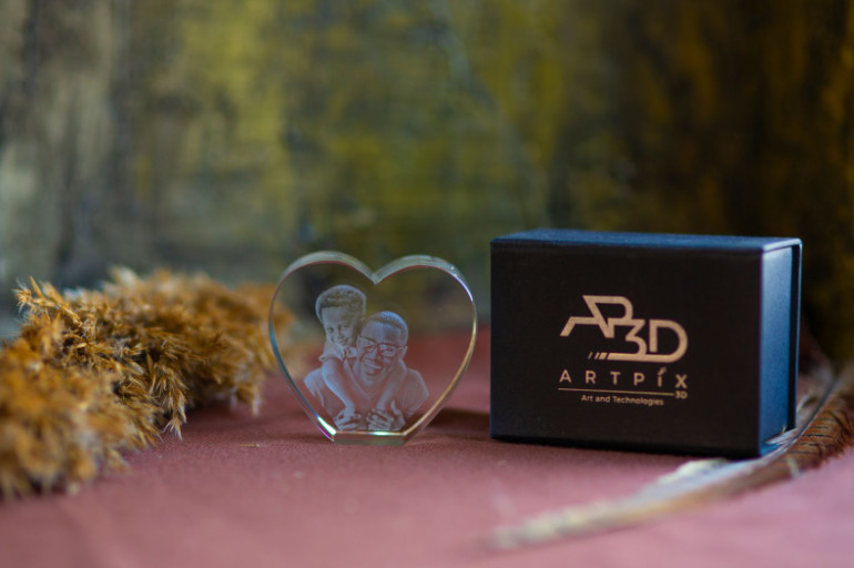 A heart-shaped crystal engraved with a 3D photo of a father and son.