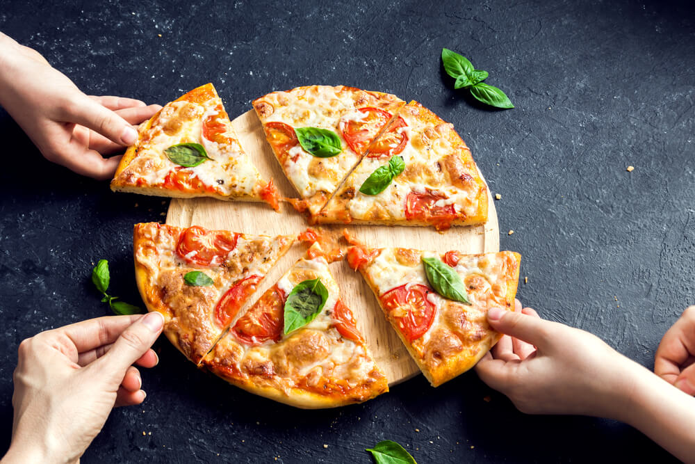 A family enjoys a delicious, homemade pizza for dinner.