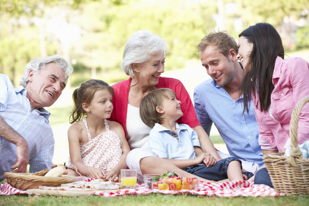 A family celebrates Mom and Grandma with an outdoor Mother’s Day picnic.