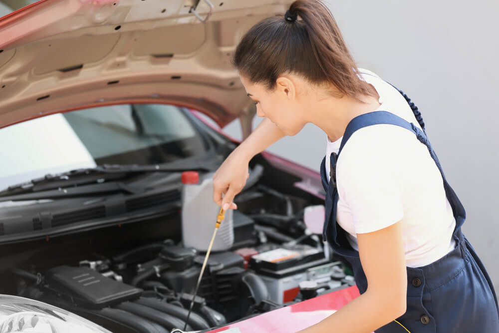 A woman in her thirties takes an auto mechanics class and learns to repair her own car.