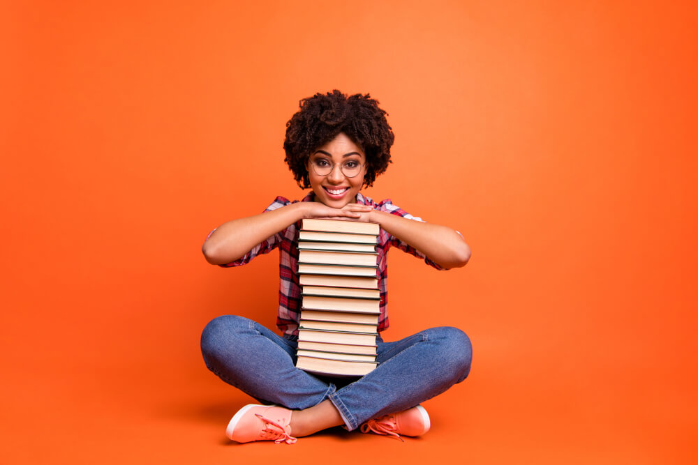 A young woman is excited to read all the books on her bucket list.