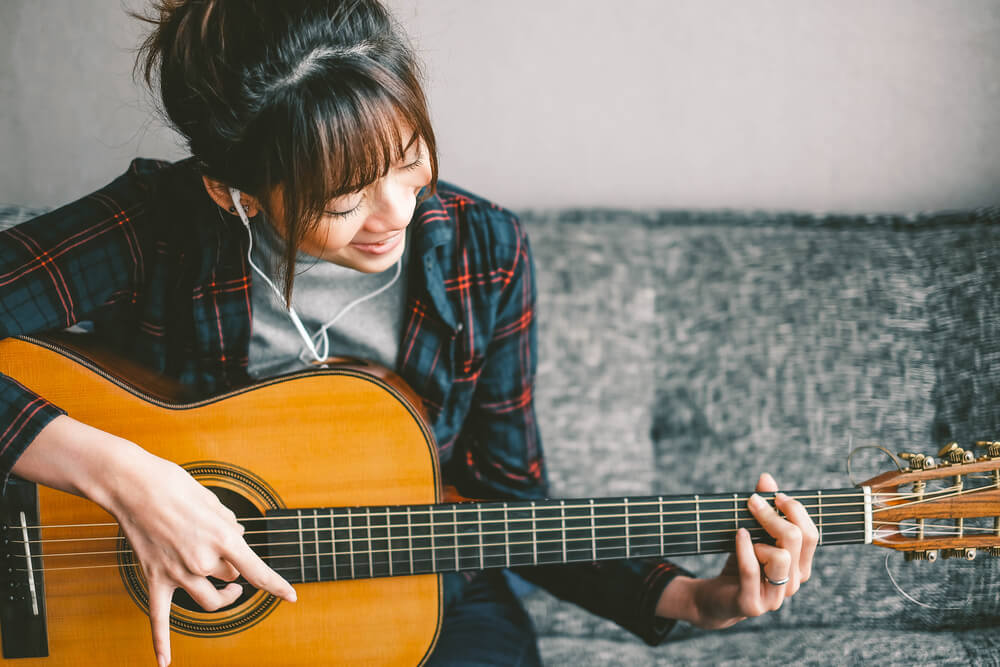 A woman learns to play guitar so she can check music lessons off her bucket list.