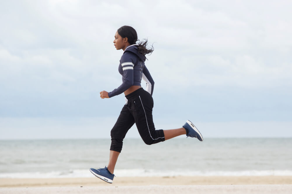 An active woman in her thirties stays fit by jogging regularly.