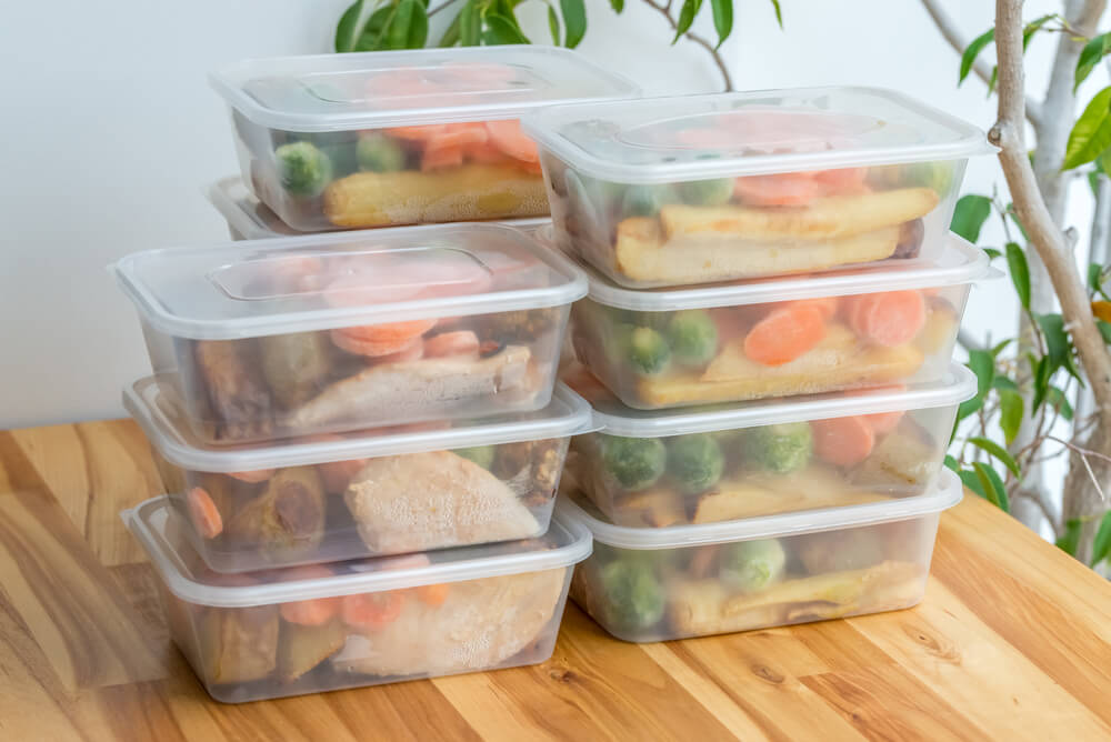Food storage containers filled with prepped ingredients for easy cooking.