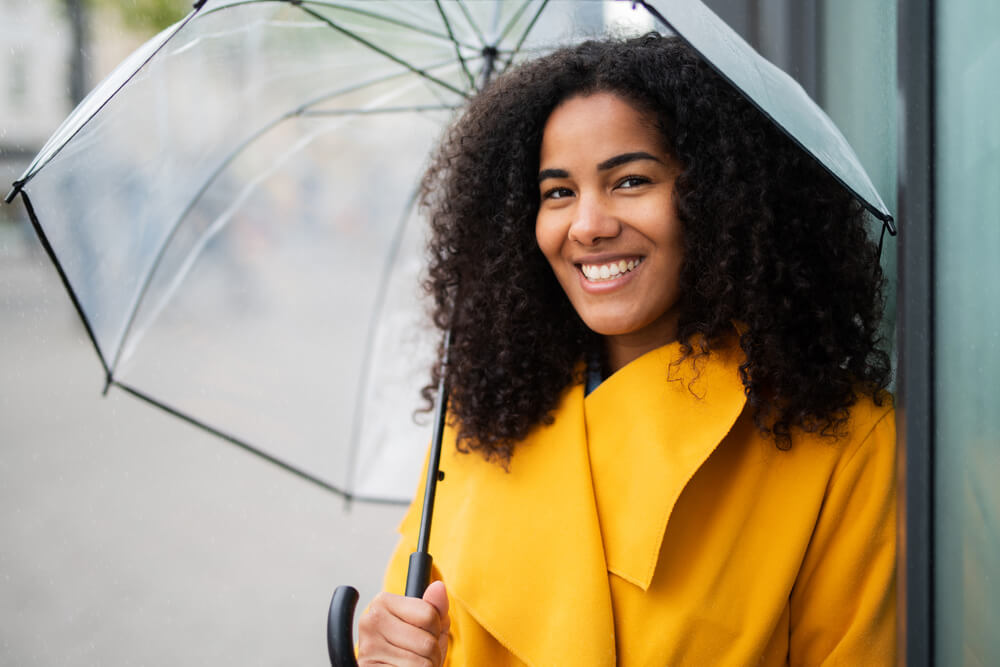 A woman stays dry on a rainy spring day with an umbrella.