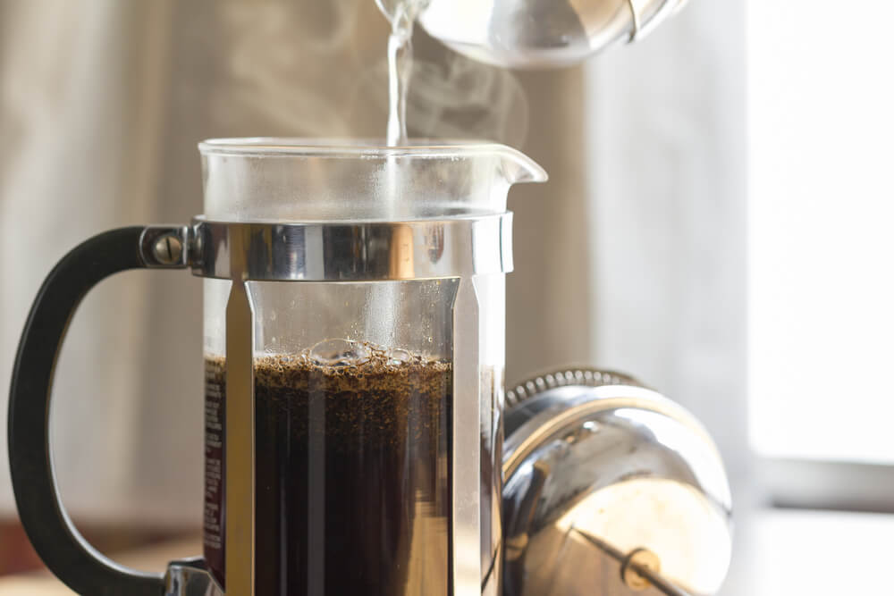 Coffee is brewing inside a single-serve French press.