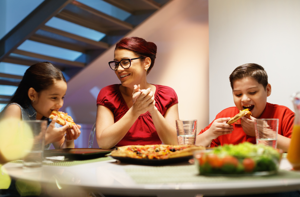 A loving single mom enjoys a family dinner with her children.