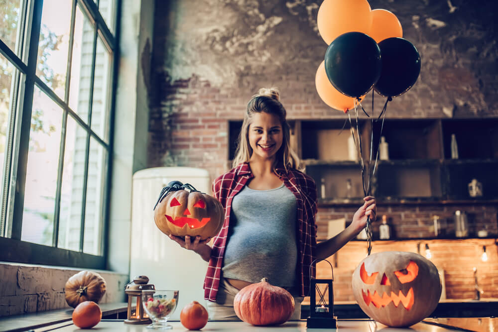 A mom-to-be loves the spooky decorations at her Halloween baby shower.